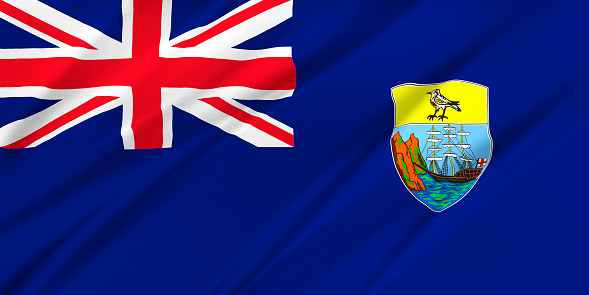 Flag of Saint Helena, Ascension and Tristan da Cunha waving in the wind