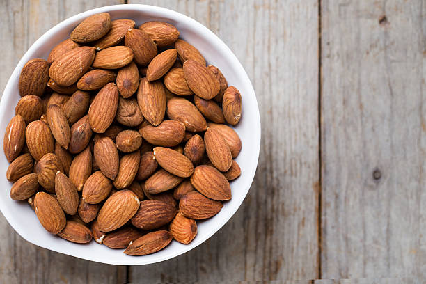 istock Almond nuts on wood background 474622630