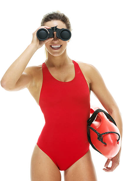 istock Female lifeguard with life buoy and binoculars 474624132