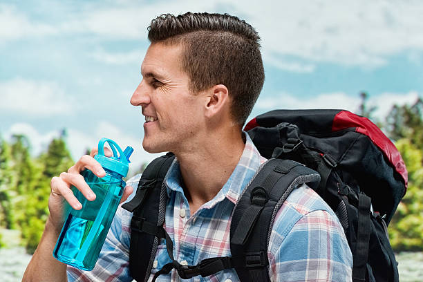 istock Smiling hiker drinking water and looking away 474624234