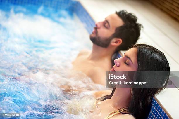 Couple Relaxing In Spa Hot Tub Stock Photo - Download Image Now - Hot Tub, Heat - Temperature, Swimming Pool