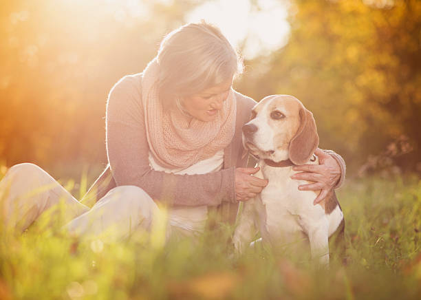 istock Active senior woman hugs dog 474624373