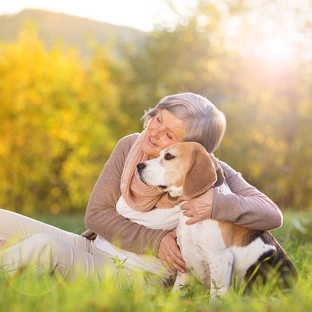 istock Active senior woman hugs dog 474624379