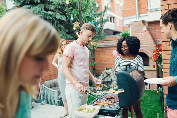 istock Young People Eating At Barbecue Party. 474624380