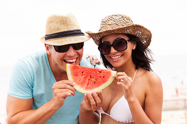istock young couple with slice of watermelon 474626742