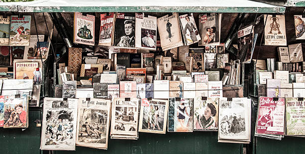 vintage news kiosk in Paris Paris, France - September 22, 2013: a vintage news kiosk with old newpapers and magazines, along the Seine news stand stock pictures, royalty-free photos & images