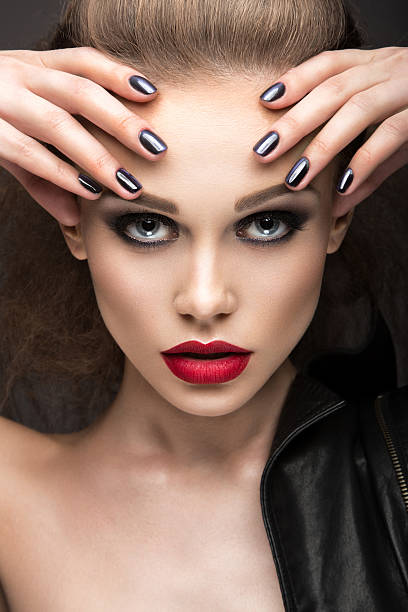 istock girl with bright makeup and manicure 