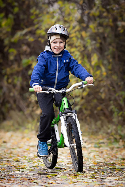 istock boy rides a bike 474636010