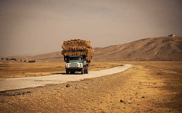 istock truck with straw on the road 474638171
