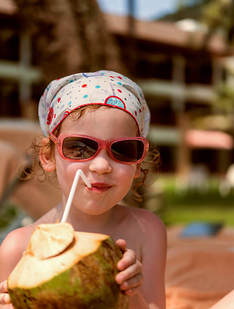 istock Girl with coconut on beach 474639968