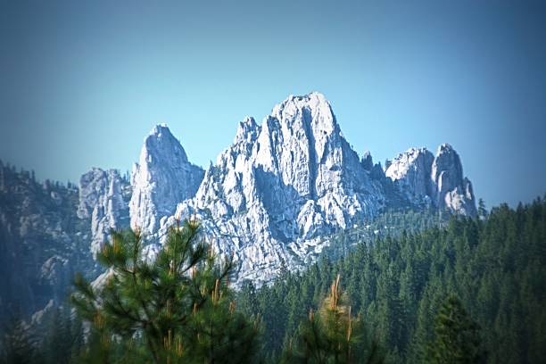 Castle Crags Of Northern California Castle Crags is a dramatic and well-known rock formation in Northern California. Elevations range from 2,000 feet along the Sacramento River near the base of the crags, to over 6,500 feet at the summit of the tallest crag. Situated along an ancient trade and travel route known as the Siskiyou Trail, Castle Crags has witnessed dramatic events. Strained relationships between 1850s California Gold Rush miners and the local native Indian populations resulted in the 1855 Battle of Castle Crags, in which the poet Joaquin Miller was wounded, and which he later described in an essay of the same name..Located just west of Interstate 5, between the towns of Castella and Dunsmuir, Castle Crags is today a popular tourist stop along the highway. mt shasta stock pictures, royalty-free photos & images