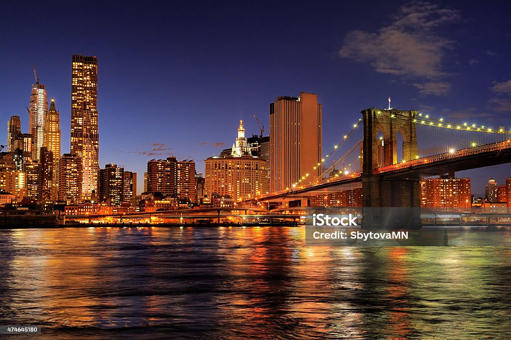New York City Brooklyn Bridge at night New York City Brooklyn Bridge with downtown skyline over East River at night 2015 Stock Photo