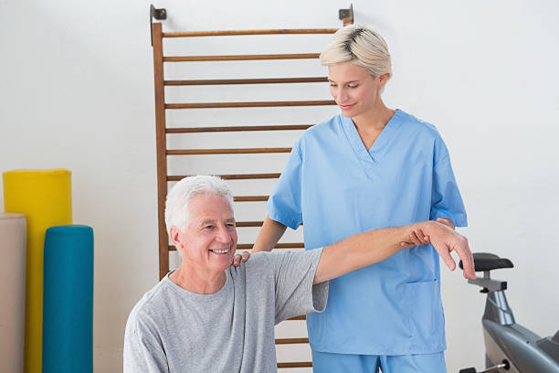 istock Senior man stretching with his therapist 474645496