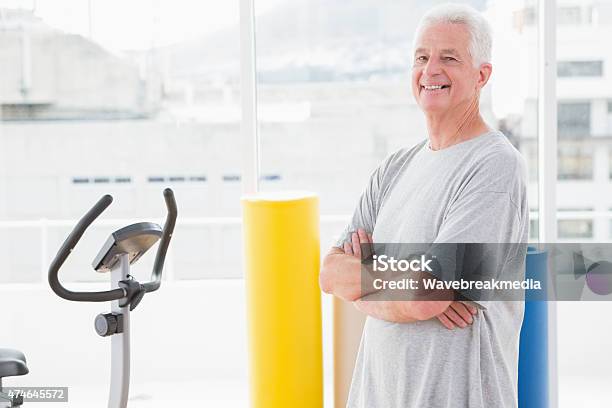 Smiling Senior Man With Arms Crossed Stock Photo - Download Image Now - 2015, 60-69 Years, 65-69 Years