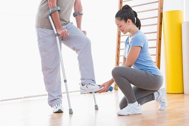 istock Coach helping senior man to walk 474645698