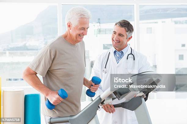 Senior Man On Treadmill With Therapist Stock Photo - Download Image Now - Doctor, Treadmill, Senior Men