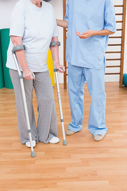 istock Therapist helping senior woman with scrubs 474648092