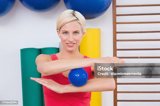 Blonde Woman With Massage Ball Stock Photo - Download Image Now - 20-29 Years, 2015, 25-29 Years