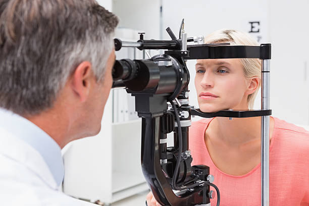 istock Optometrist examining blonde woman 474648358