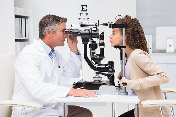 istock Woman doing eye test with optometrist 474648398