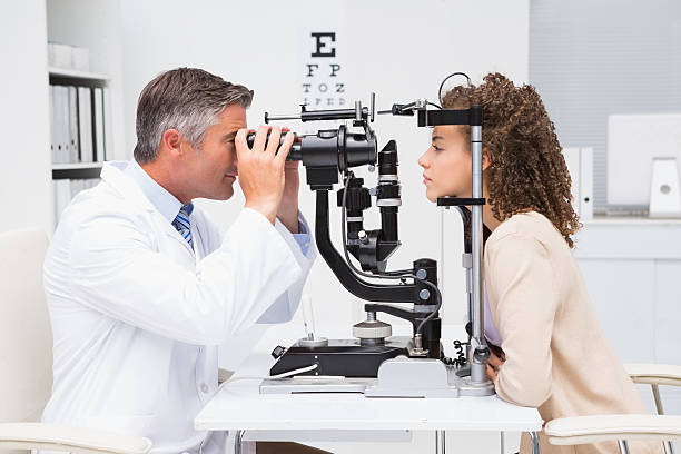 Woman doing eye test with optometrist Woman doing eye test with optometrist in medical office  optometry stock pictures, royalty-free photos & images