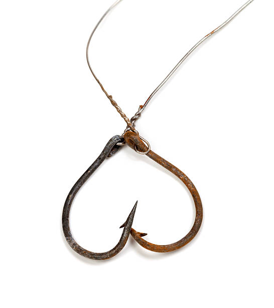 istock Old rusty fish hooks in form of heart 474648438