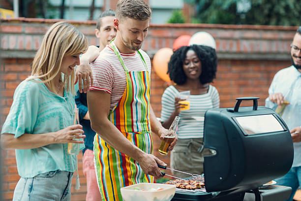 istock Young People Eating At Barbecue Party. 474649262