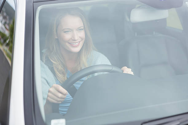 istock Young woman driving 474652932