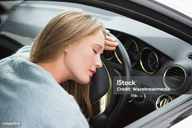 Tired Woman Asleep On Steering Wheel Stock Photo - Download Image Now - 20-29 Years, 2015, 25-29 Years