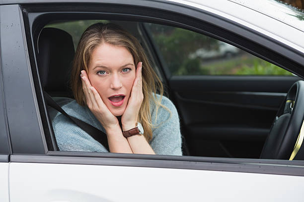 istock Shocked woman sitting in drivers seat 474652986