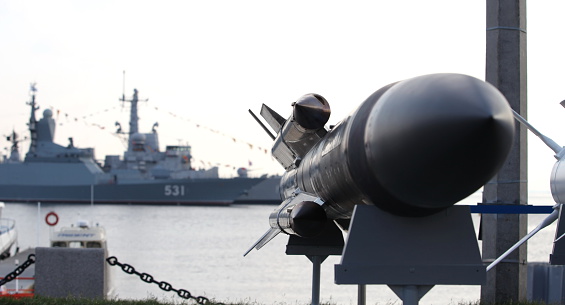 Navy frigate moored at naval dockyard.