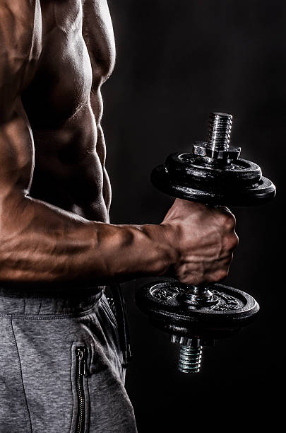 istock Strong Hand of Bodybuilder holding weights 474655226