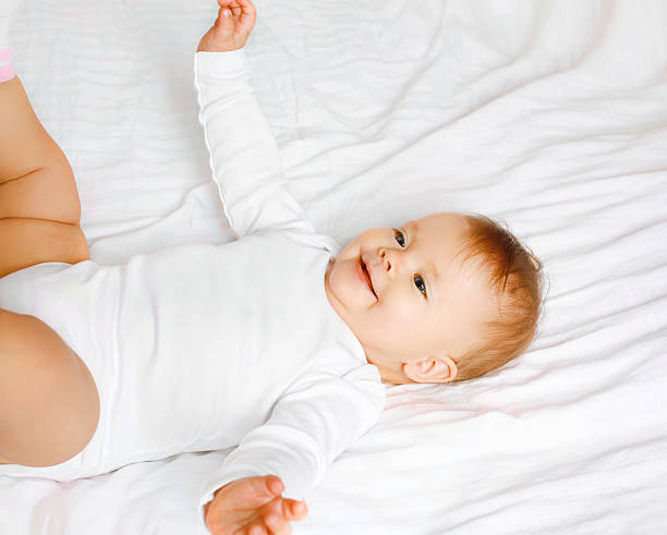 istock Sweet baby lying on the bed, top view 474657724