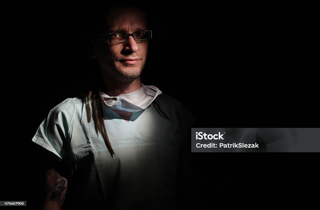 Portrait of  male nurse ICU  with tattoo and dreadlocks. Portrait of  male nurse ICU  with tattoo and dreadlocks on black background Males Stock Photo
