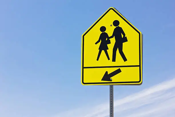 School crosswalk and arrow sign.