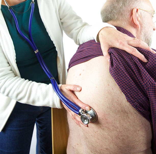 istock Doctor inspects a patient by listening with a stethoscope 474661176