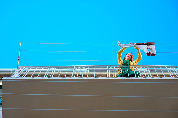 istock Woman with phone on the balcony 474661382