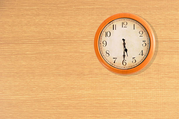 istock Clock showing 5:30 o'clock on a wooden wall 474664642