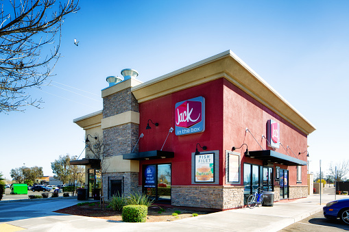 Hollister, USA - March 6, 2015: Jack in the box stand alone franchise restaurant, photographed in Central California on a clear winter day. a bike and a car are parked nearby.