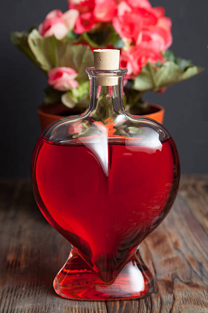 istock Bottle with red wine and flower 474668740