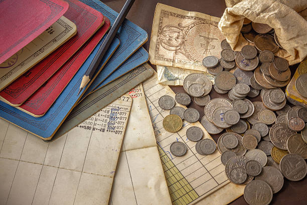 istock Old coins and bank book on grunge background. 474671691