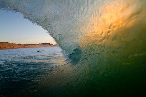 barreling wave in evening light at french beachbreak