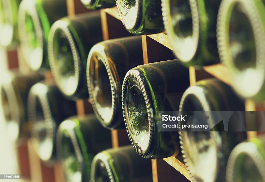 stacked of old wine bottles stacked of old wine bottles in the cellar,dusty but tasty Alcohol Abuse Stock Photo