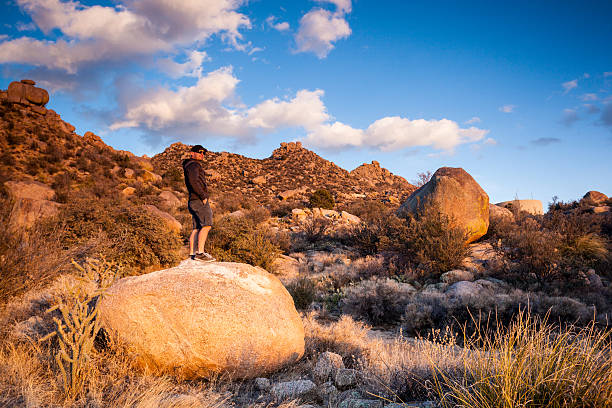 istock man and southwest landscape sunset 474675693