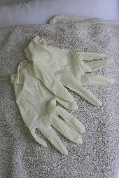istock Used disposable gloves on a white towel. 474683704