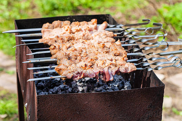 istock skewers with shish kebabs on grill on backyard 474683804