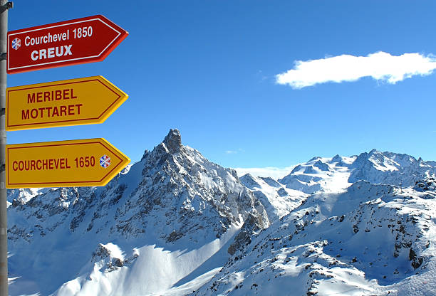 Skiresort - Val Thorens - Courchevel - Meribel Direction Sign to Courchevel and Meribel in the skiresort Val Thorens, France with mountainrange in the background. courchevel stock pictures, royalty-free photos & images