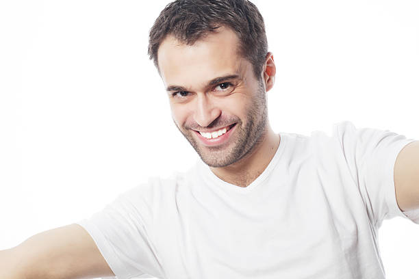 istock young man holding camera and making selfie 474687258