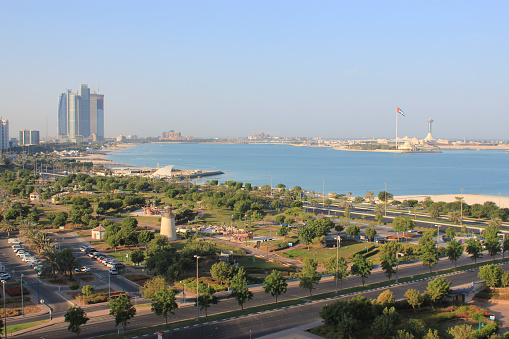 View of the coast of Abu Dhabi, in the United Arab Emirates, with modern skyscrapers, beaches, parks and crystal clear Gulf waters 