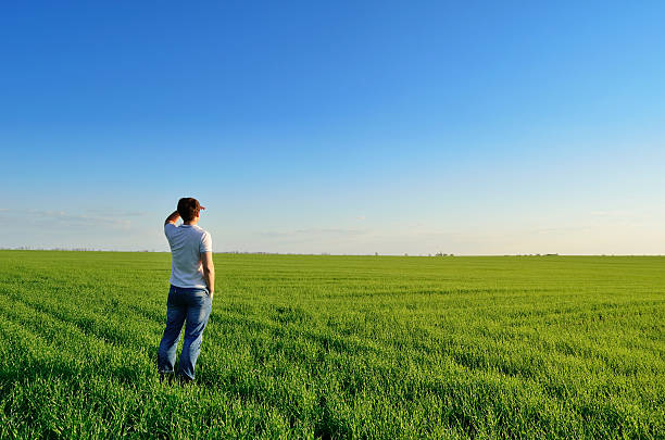 istock Man looks into the distance on the field 474688800